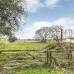 Private grassland development plot fronted by mature trees on Vineyards Road, Northaw, Potters Bar EN6, ideal for residential investment