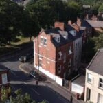 Residential building plot on College Grove Road, Wakefield, featuring existing garage for demolition, full planning for 2-bed home
