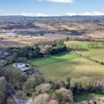 Gently sloping grassland parcel in Forest Hill Hartford, enclosed by post and rail fencing and hedgerows, ideal for equestrian grazing