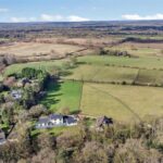 Expansive grassland field on Forest Hill, Hartford, with post and rail fencing, hedgerows and gated access for grazing or development