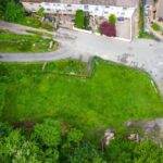 Lush woodland surrounding prime 0.25-acre development site on Astley Street, Darwen with planning for luxury 3-bed home