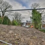 View of cleared residential development land featuring a front-to-rear drop, ready for two semi-detached houses in Blackburn