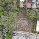 Aerial view of cleared residential land on Leopold Road, Blackburn, showing front-to-rear drop, ready for semi-detached house development