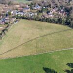 Versatile grassland field with post and rail fencing, hedgerows, and gated access in semi-rural Hartford, ideal for equestrian grazing or development