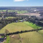 Mature hedgerows, post and rail fencing enclosing gently sloping 3.74 acre grassland for sale in Forest Hill, Hartford, Cheshire Green Belt